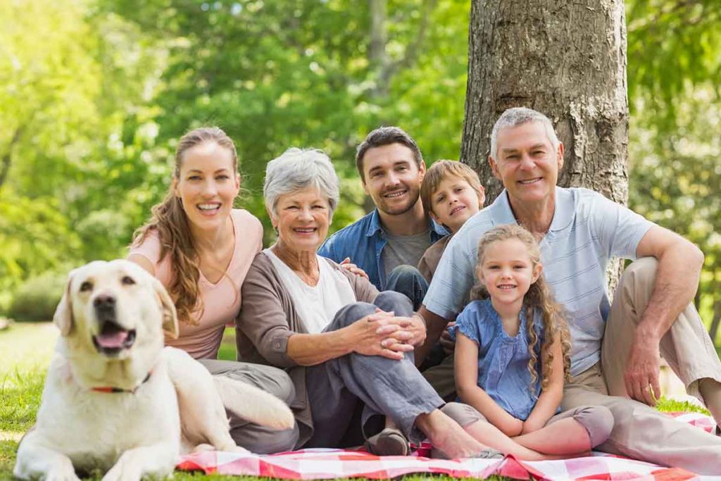 Multi-generational family outside together with a dog